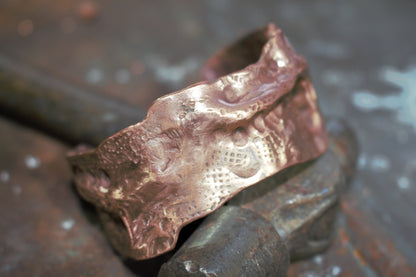 close up of an airchased bcopper cuff heavy with textures