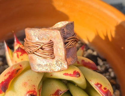 Reticulated copper ring, heavy in structural feel, encased with copper wire