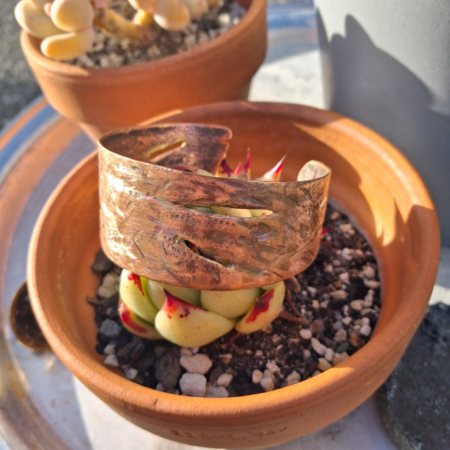 Shimmery copper cuff with delicate slits and hand hammered textures