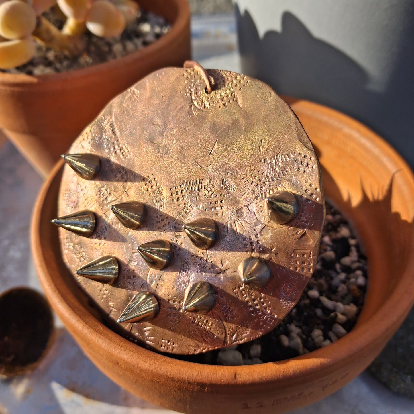 Textured copper disc with stainless steel spikes